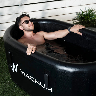 A man having a cold plunge in a PolarEdge tub from the WAGNUM brand.